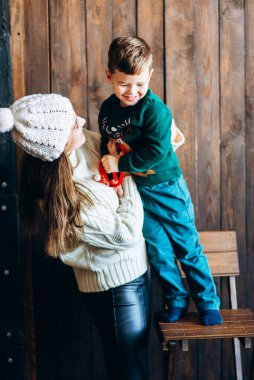 Woman in knitted outfit enjoying time with small boy