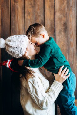 Woman in knitted outfit enjoying time with small boy