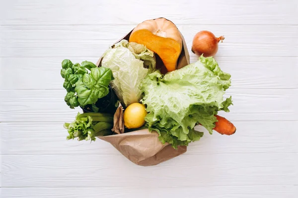 Zero waste concept. Package-free food shopping. Eco friendly paper bag with organic vegetables. Sustainable lifestyle concept. Plastic free items. Reuse, reduce, refuse.