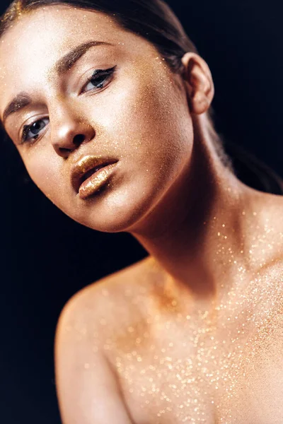 Beauty fashion art model girl with Golden skin. Close up portrai