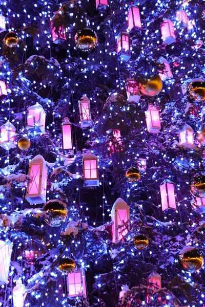 Albero di Natale primo piano di sfondo di colore blu fantasma con lanterne di legno bianche, palle di Natale d'oro e luci . Immagine Stock