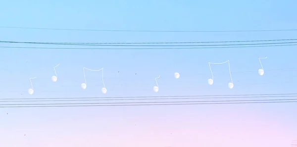 Creative manipulated surrealisstic abstract photo of the white moon on electric wires on a blues pink sky background. — Stock Photo, Image