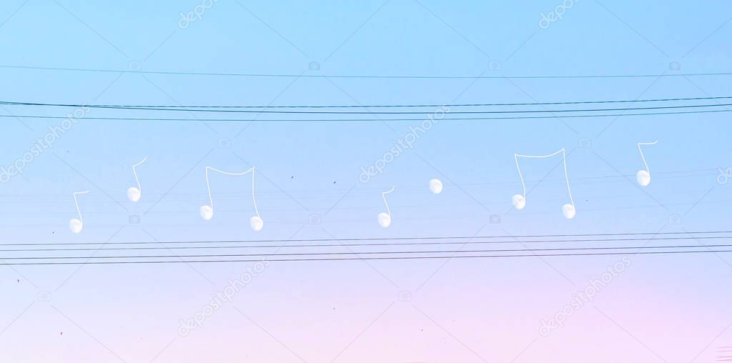 Creative manipulated surrealisstic abstract photo of the white moon on electric wires on a blues pink sky background.