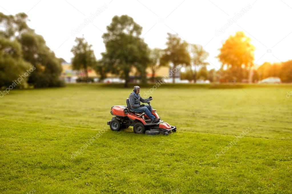 man drives a lawnmower