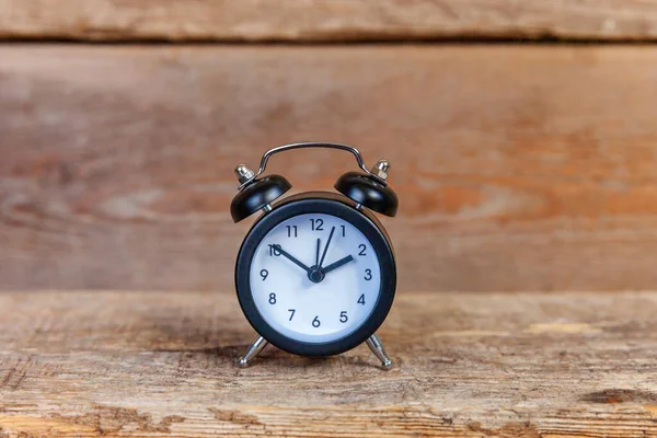 Vintage alarm clock on wooden background — Stock Photo, Image