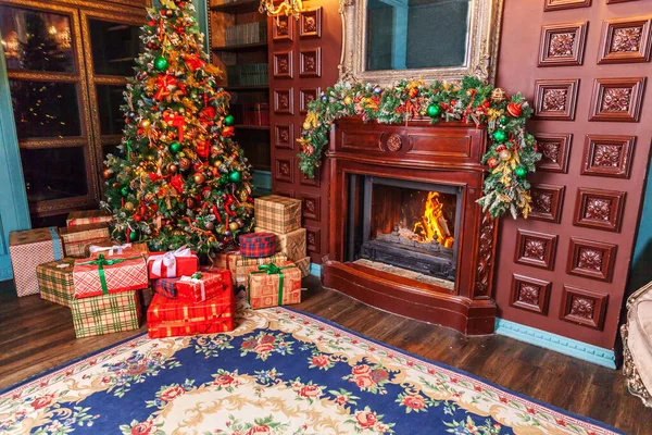 经典的圣诞新年装饰室内图书馆与壁炉。 圣诞树，装饰着红色装饰品。 现代古典风格室内设计公寓。 平安夜在家里. — 图库照片