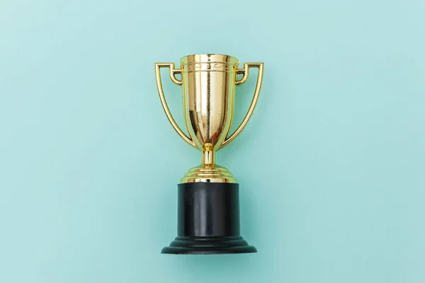 Winner or champion gold trophy cup isolated on blue pastel colorful background