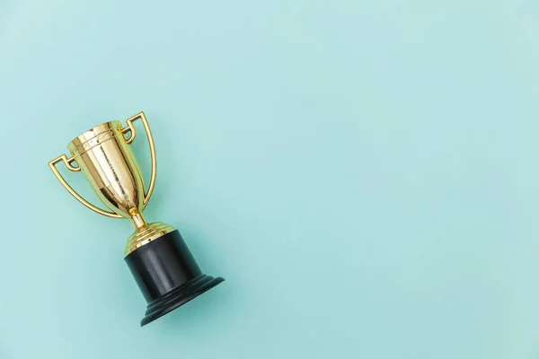 Winner or champion gold trophy cup isolated on blue pastel colorful background — Stockfoto