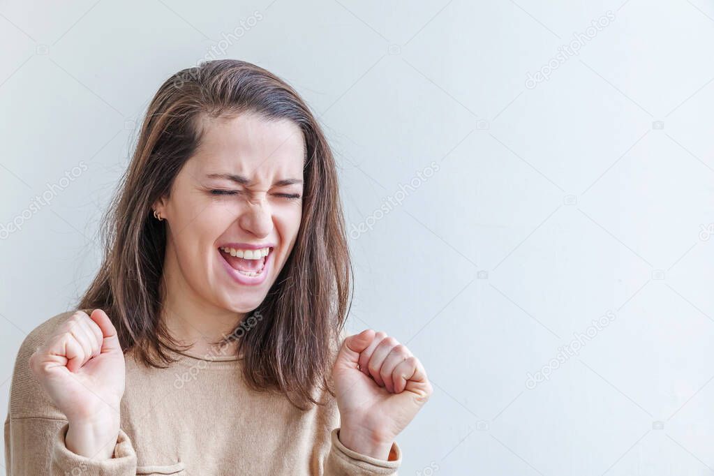 Happy girl smiling. Beauty portrait young happy positive laughing brunette woman on white background isolated. European woman. Positive human emotion facial expression body language