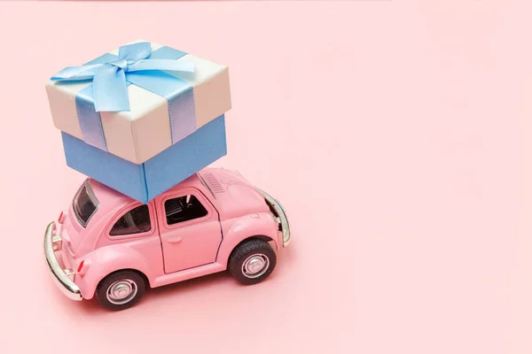 Egyszerűen tervezés rózsaszín vintage retro játék autó szállít ajándék doboz a tetőn elszigetelt trendi pasztell rózsaszín háttér. Karácsony újév születésnap Valentin-nap ünneplés jelen romantikus koncepció — Stock Fotó
