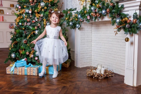 Nieuwjaar 2020 Vrolijk kerstfeest. Meisje dat kerstboom versiert op kerstavond december thuis. Jong kind in de slaapkamer met winterdecoratie. Tijd voor een feestelijk concept — Stockfoto