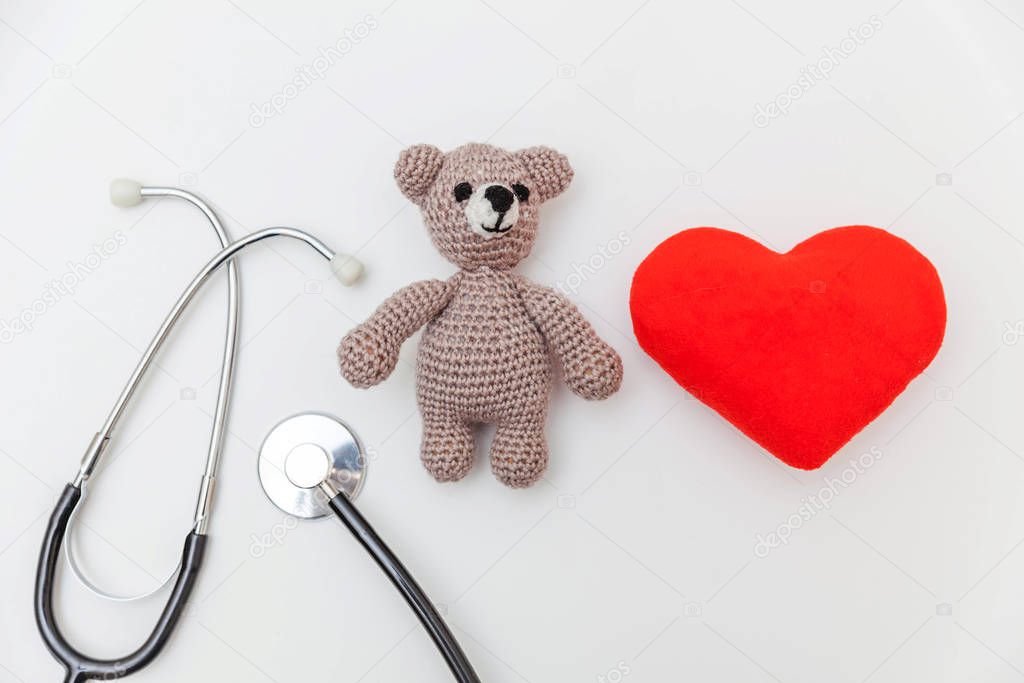 Simply minimal design toy bear red heart and medicine equipment stethoscope isolated on white background. Health care children doctor concept. Pediatrician symbol. Flat lay, top view copy space