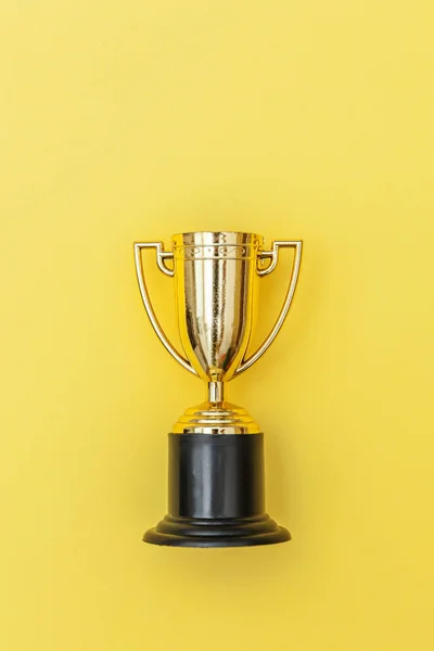 Winner or champion gold trophy cup isolated on yellow colorful background — Stock Photo, Image