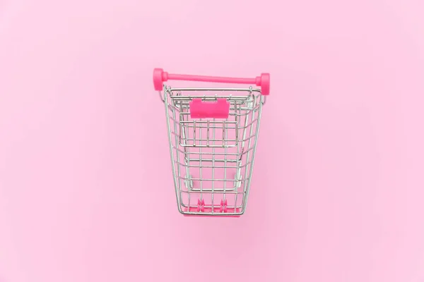 Small supermarket grocery toy push cart isolated on pink pastel colorful background — Stock Photo, Image