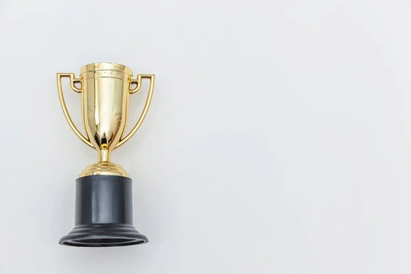 Simply flat lay design winner or champion gold trophy cup isolated on white background. Victory first place of competition. Winning or success concept. Top view copy space. — Stock Photo, Image