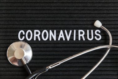 Text phrase Coronavirus and stethoscope on black letter board background. Novel coronavirus 2019-nCoV, MERS-Cov middle East respiratory syndrome coronavirus originating in Wuhan China