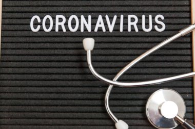 Text phrase Coronavirus and stethoscope on black letter board background. Novel coronavirus 2019-nCoV, MERS-Cov middle East respiratory syndrome coronavirus originating in Wuhan China