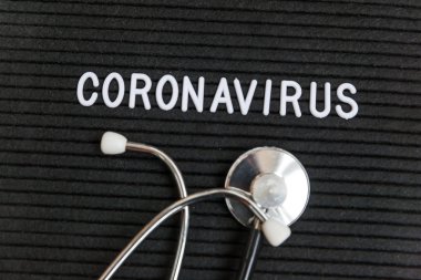 Text phrase Coronavirus and stethoscope on black letter board background. Novel coronavirus 2019-nCoV, MERS-Cov middle East respiratory syndrome coronavirus originating in Wuhan China