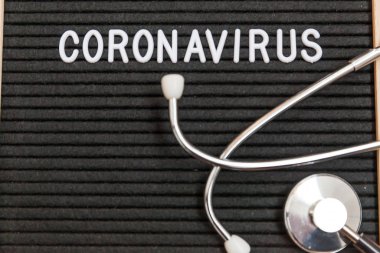 Text phrase Coronavirus and stethoscope on black letter board background. Novel coronavirus 2019-nCoV, MERS-Cov middle East respiratory syndrome coronavirus originating in Wuhan China