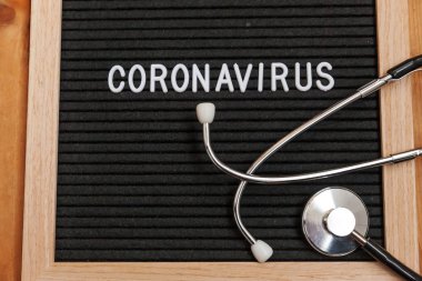 Text phrase Coronavirus and stethoscope on black letter board background. Novel coronavirus 2019-nCoV, MERS-Cov middle East respiratory syndrome coronavirus originating in Wuhan China