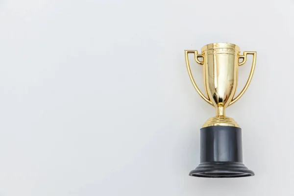 Simply flat lay design winner or champion gold trophy cup isolated on white background. Victory first place of competition. Winning or success concept. Top view copy space. — Stock Photo, Image
