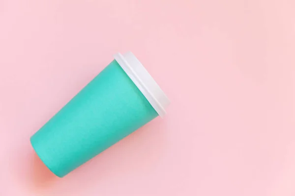 Simplesmente plana leigos projeto azul papel xícara de café no pastel rosa colorido fundo da moda — Fotografia de Stock