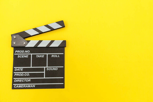 Filmmaker profession. Classic director empty film making clapperboard or movie slate isolated on yellow background. Video production film cinema industry concept. Flat lay top view copy space mock up
