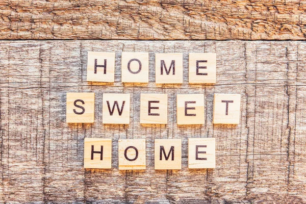 Stay Home Stay Safe. Inscription HOME SWEET HOME letters word on wooden background. Social distancing awareness. Sweet home COVID-19 Coronavirus quarantine concept