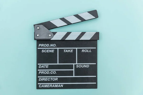 Filmmaker profession. Classic director empty film making clapperboard or movie slate isolated on blue background. Video production film cinema industry concept. Flat lay top view copy space mock up