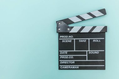 Film yapımcılığı mesleği. Klasik yönetmen boş film klapperboard ya da film tahtasını mavi arka planda izole ediyor. Video yapım film endüstrisi konsepti. Düz görünüm fotokopi alanı maketi