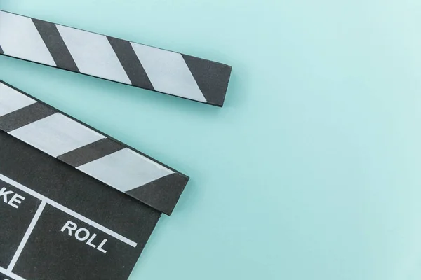 Filmmaker profession. Classic director empty film making clapperboard or movie slate isolated on blue background. Video production film cinema industry concept. Flat lay top view copy space mock up