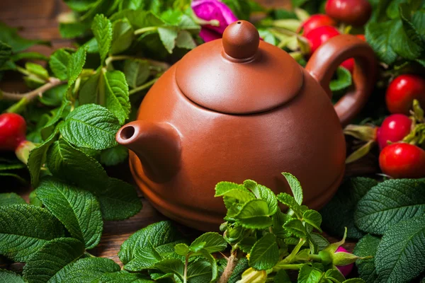 Zdravý čaj s dogrose na dřevěný stůl — Stock fotografie