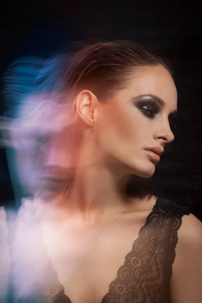 Closeup portrait of a serious lady with smoky eye makeup — Stock Photo, Image