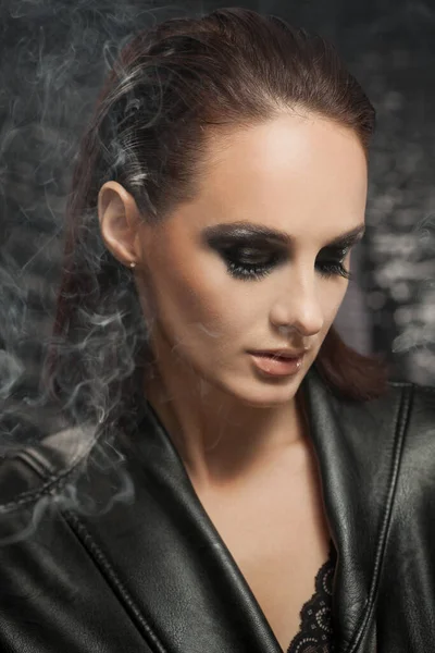 Closeup portrait of a serious lady with smoky eye makeup — Stock Photo, Image