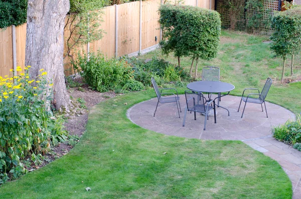 Circular garden patio with table and chairs