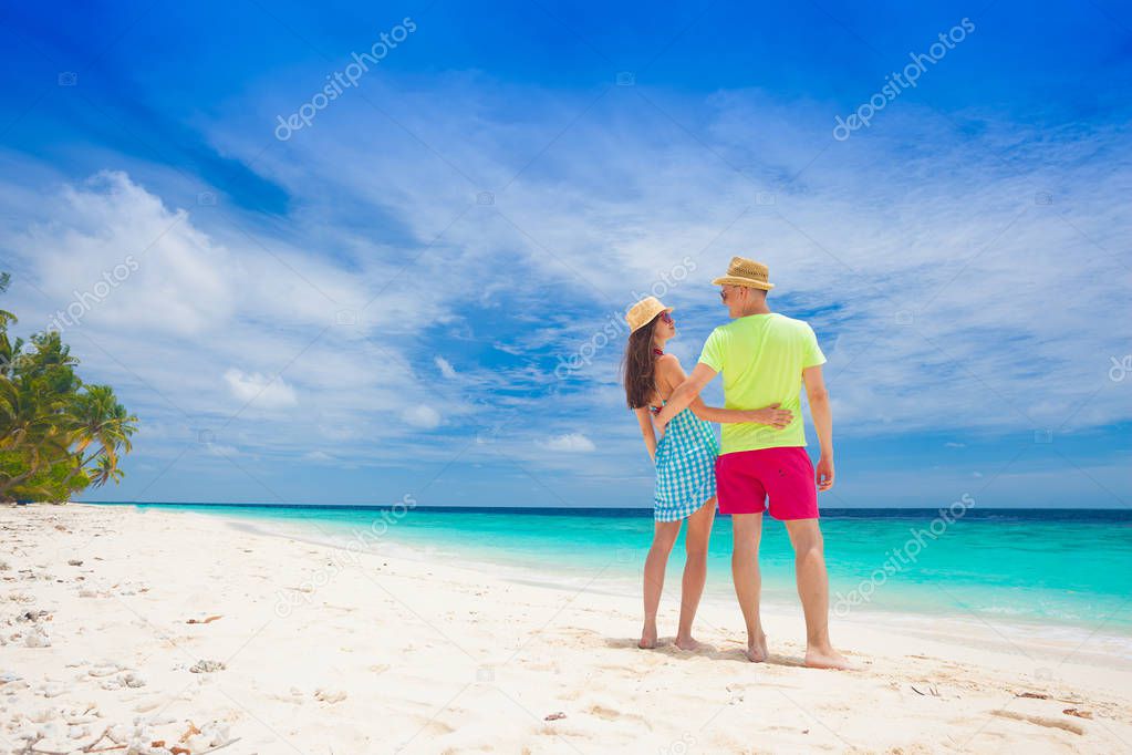 happy young couple having fun by the beach