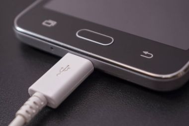 Beyaz kablo siyah zemin üzerine siyah smartphone