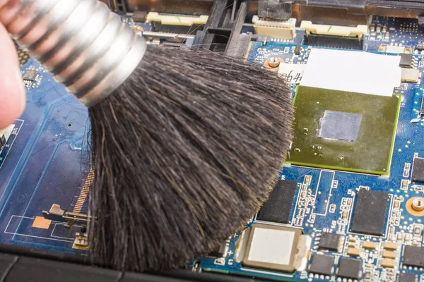 Cleaning the motherboard with a brush