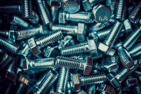New shiny metal bolts in the heap — Stock Photo, Image