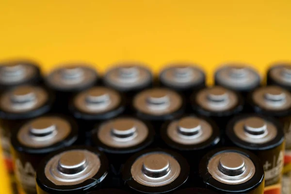 Used batteries are arranged in a triangle shape. Recycling and d — Stock Photo, Image