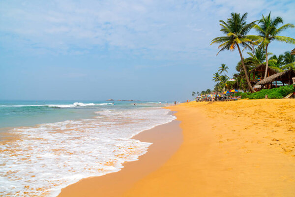 Distant hotel in sandy beach in Mirissa, Sri Lanka, Asia