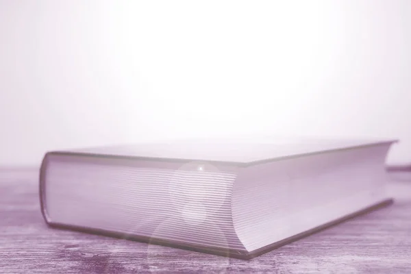 book on table on light background
