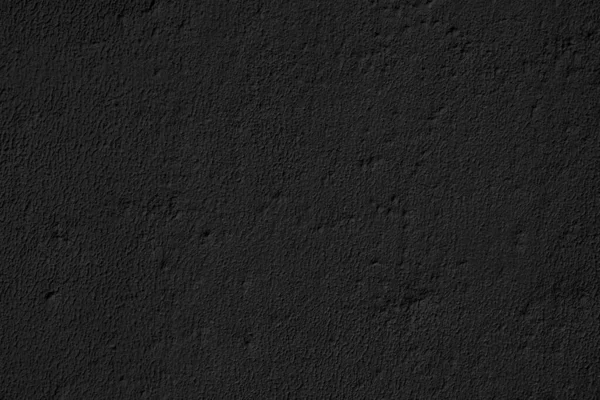 Abstract black background. Black stucco texture. Dark rough surface.