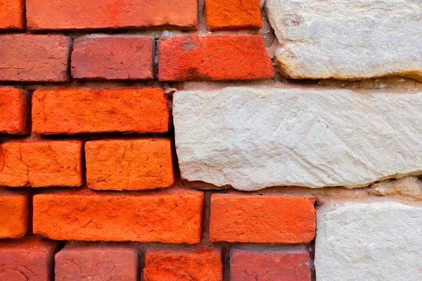 Wall of red and white bricks. Brick background. Old house wall.