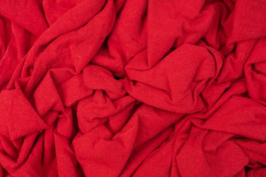 Buruşmuş yün katları. Tekstil ürünü. Soyut kırmızı arkaplan.