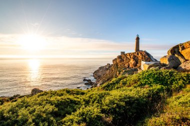 Cape Vilan Lighthouse, Cabo Vilano, in Galicia at sunset, Spain clipart