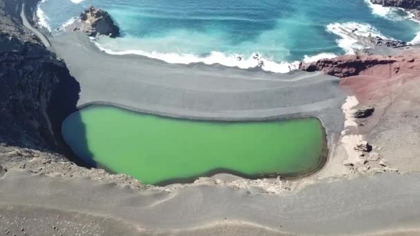 El Golfo green lagoon and ocean with black volcanic beach. Lanzarote.aerial view Royalty Free Stock Video