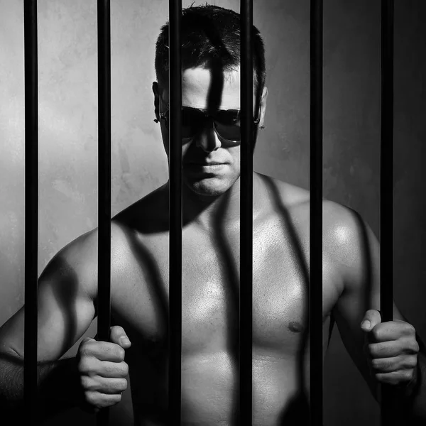 Sexy man behind bars
