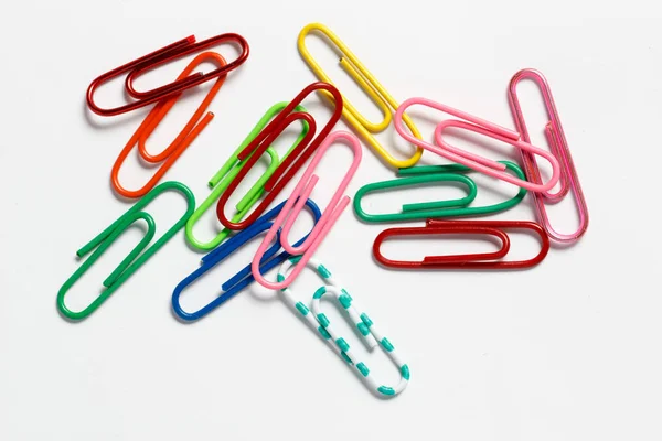 Multicolored paper clips on a white background — Stock Photo, Image