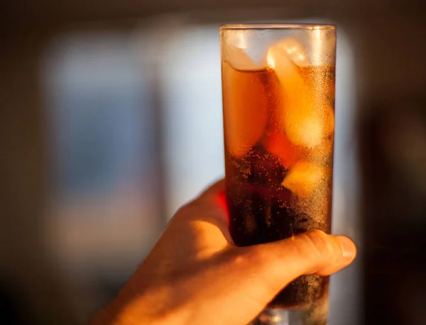 Hand with a glass of rum with cola, A cool drink! Summer Cocktail